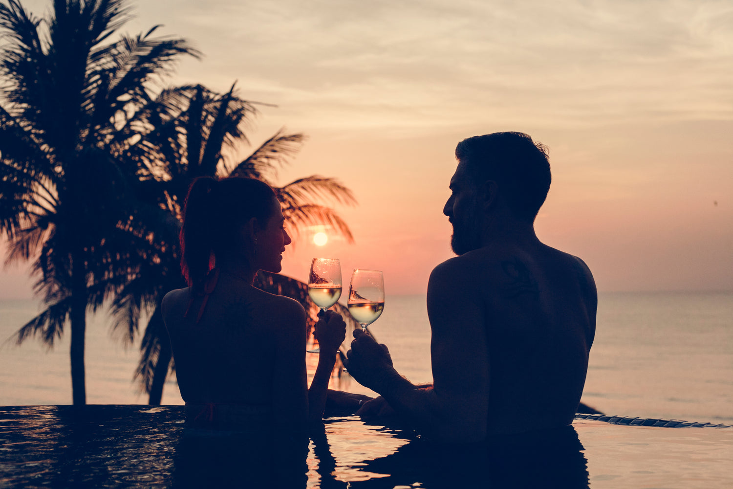 The couple's sunset pool date is made even more luxurious with the use of elegant wine chillers to keep their champagne at the ideal temperature.